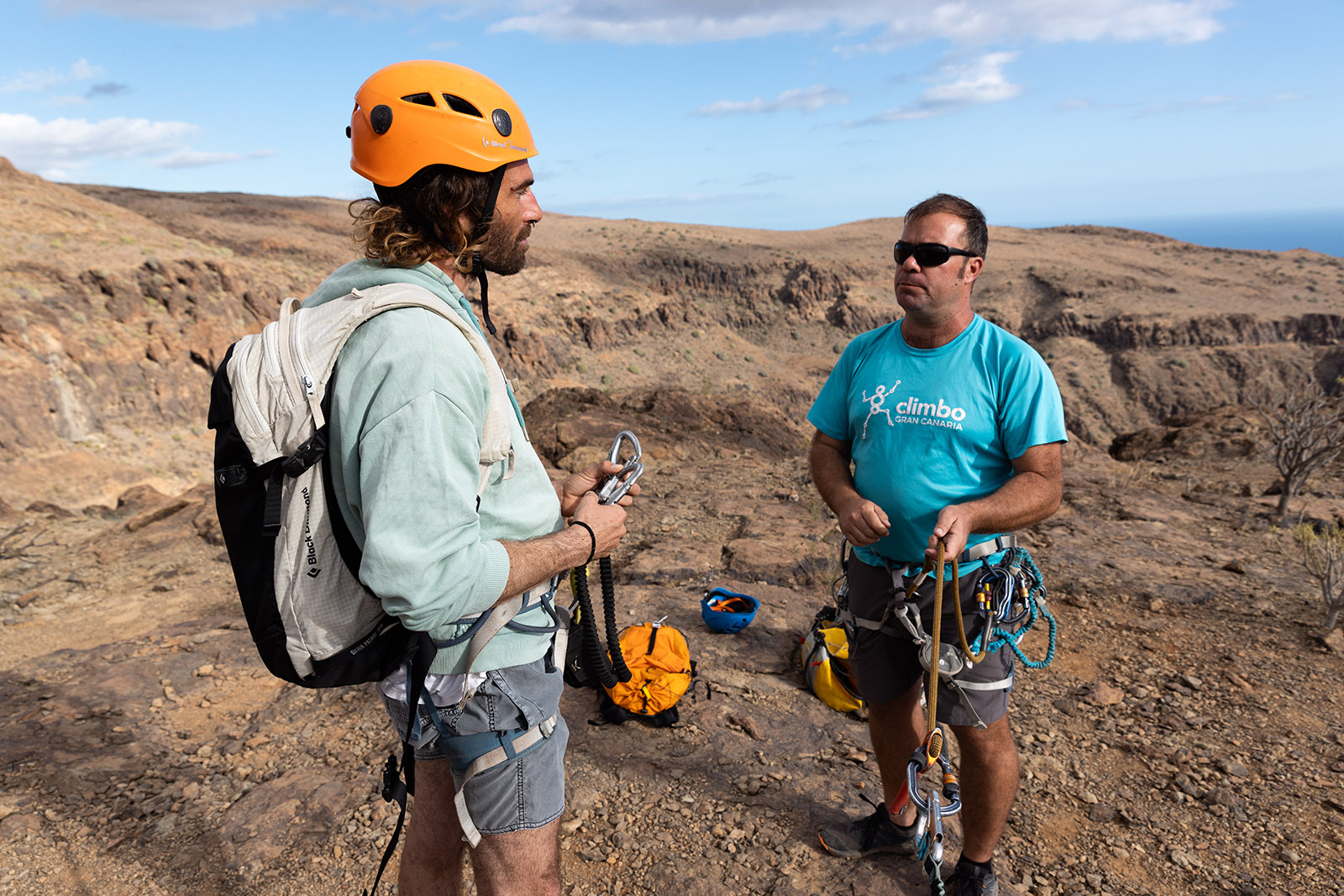 Víctor España, guía de Climbo, enseñando a Llorenç los tecnicismos de la vía y repasando cómo funciona el material. La seguridad y el conocimiento nos dan la confianza necesaria para pasarlo bien. Fotografía Lugares de Aventura. Autora: Júlia Miralles. 